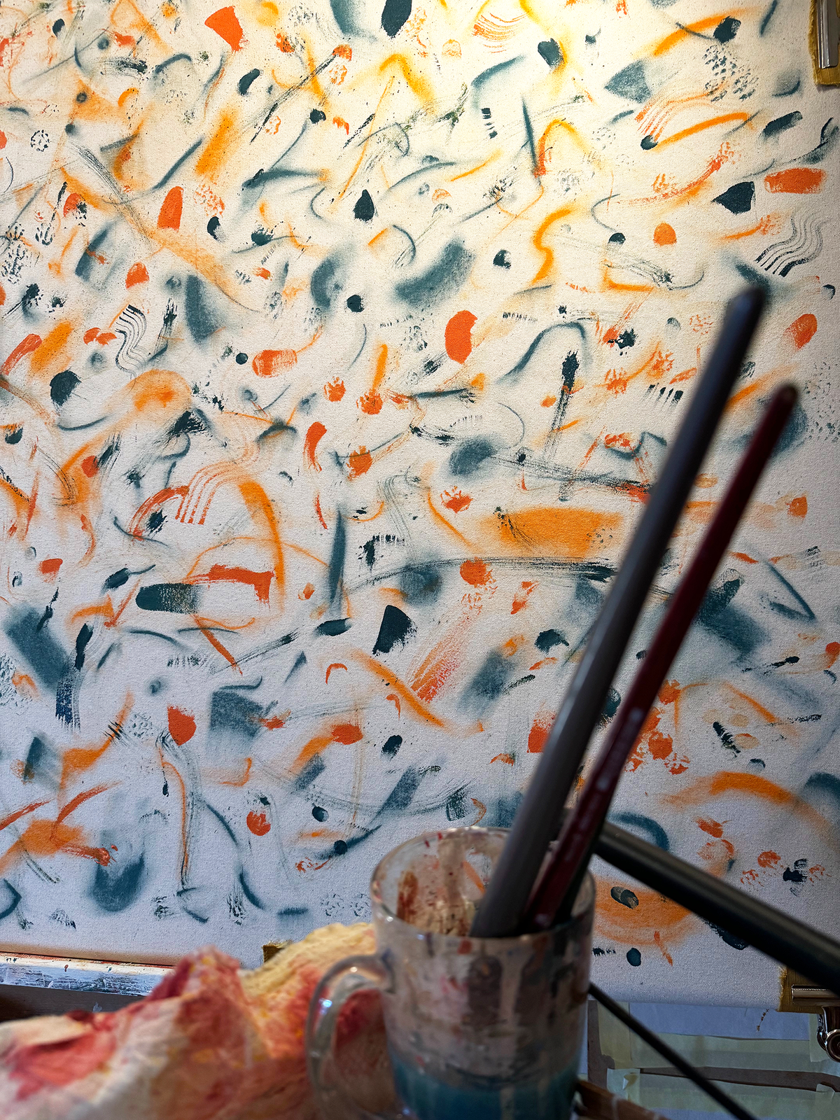Abstract expressionism artwork on raw cotton canvas. Colours are orange tones, dark and light blue/teal brush strokes. Organic patterns and faces expressing different emotions. Layers of painting.  Made by Studio Thicia Luiza